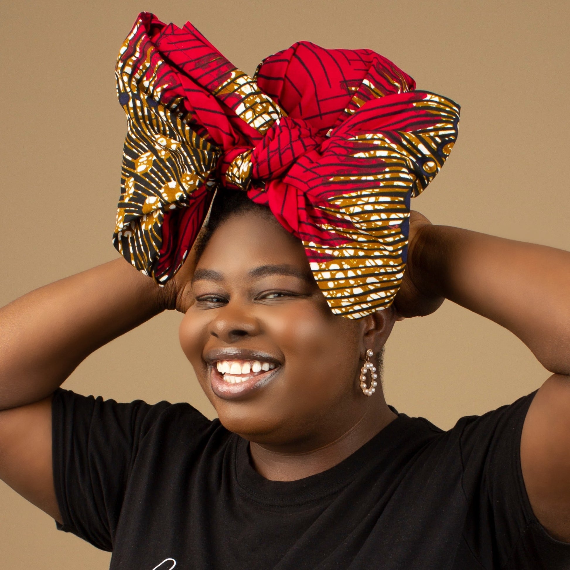 The Ata African Print Head Wrap is a lightweight African Print hair accessory made from ethically produced cotton. The Ankara wax print is a gorgeous red, white and black oversized textured swirl African Print pattern. Designed in England Made in Nigeria.