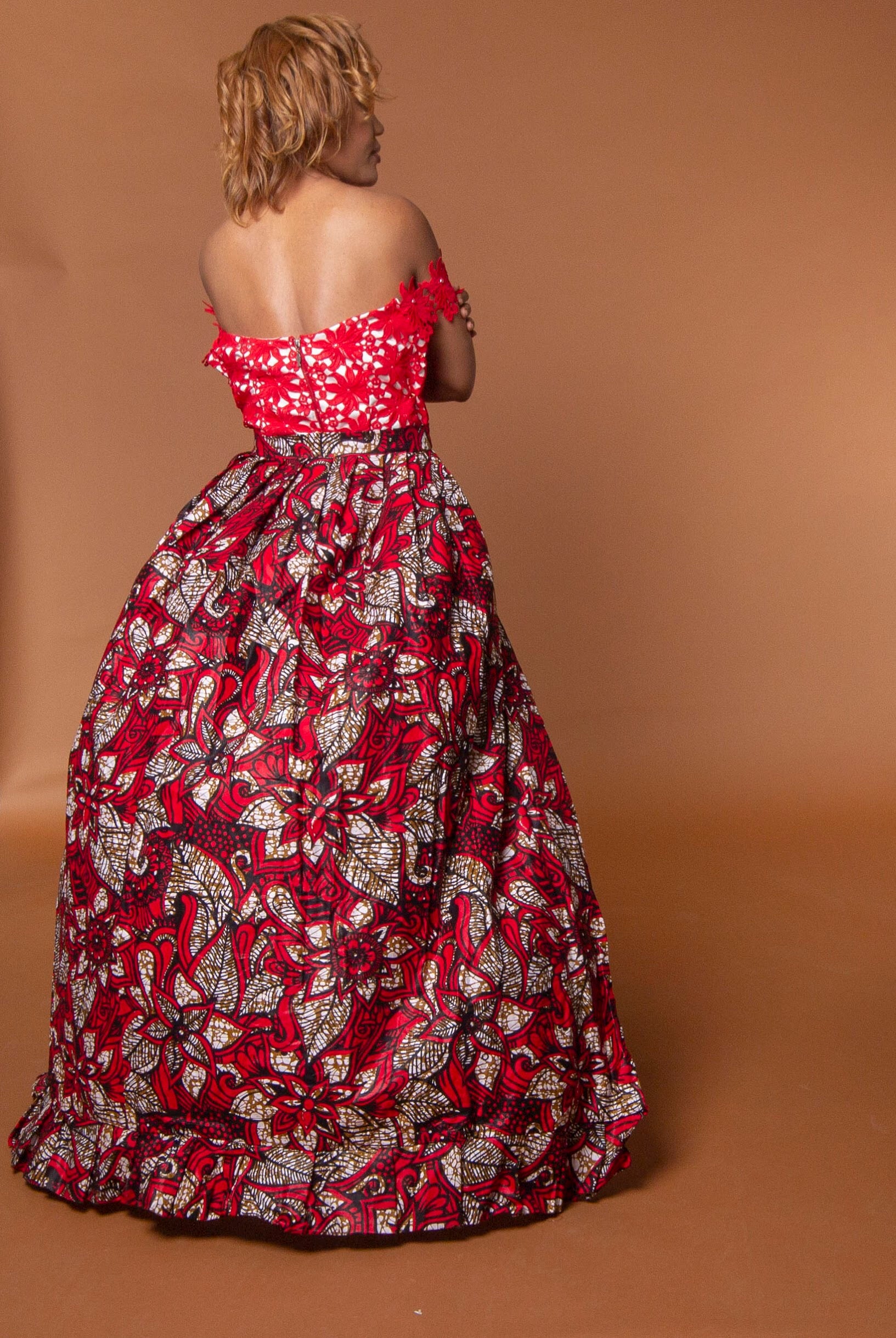 Back view of red african print cape in floral ankara wax print fastened at the waist
