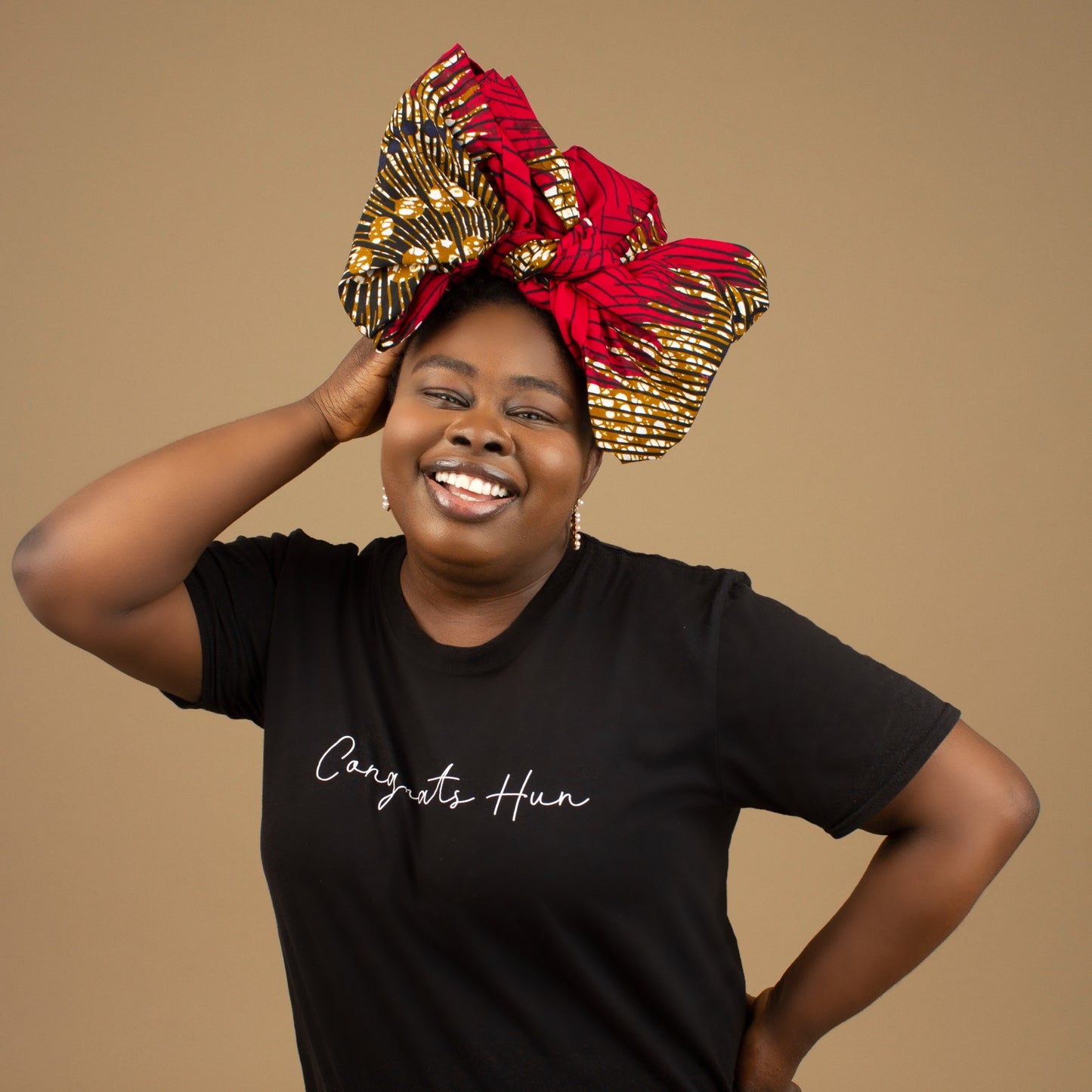 The Ata African Print Head Wrap is a lightweight African Print hair accessory made from ethically produced cotton. The Ankara wax print is a gorgeous red, white and black oversized textured swirl African Print pattern. Designed in England Made in Nigeria.