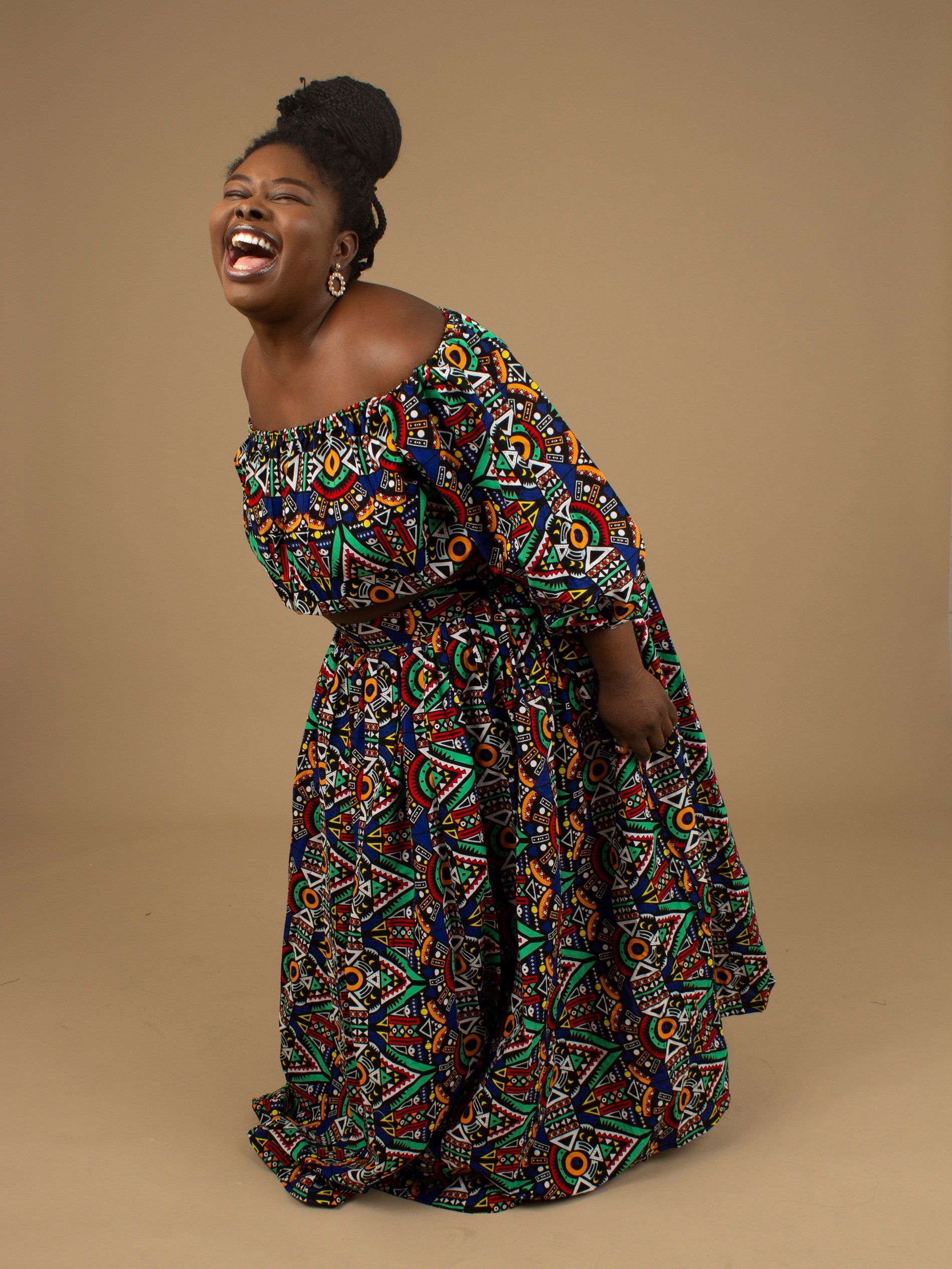 The Ifemi Floor Length African Print High Waisted Maxi Skirt with an enforced waistband and zip in a vibrant Ankara wax, geometric multicolored pattern using sustainable ethically sourced Cotton, designed in England Made in Nigeria.