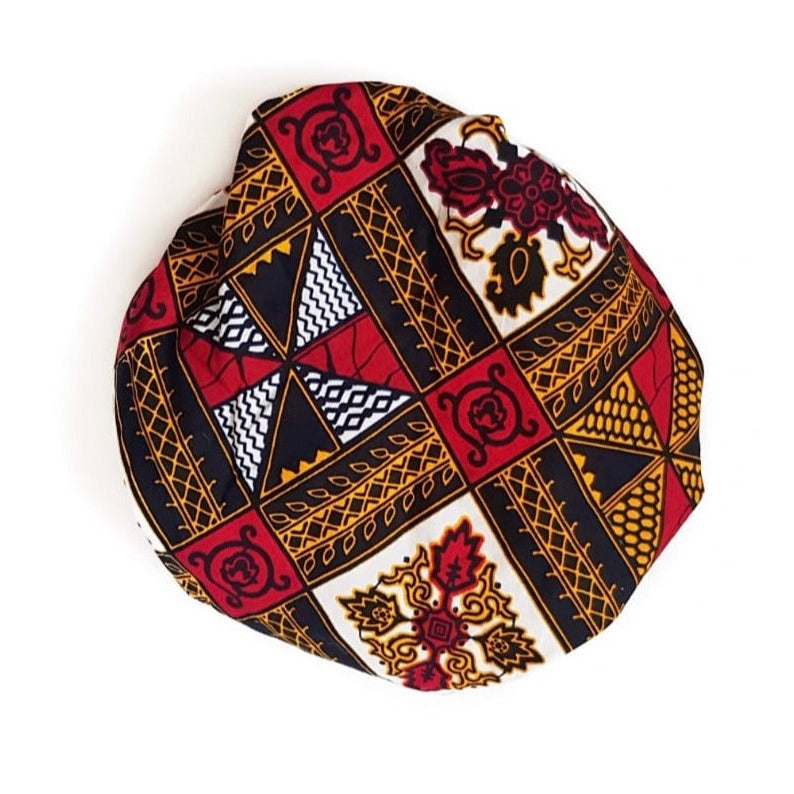African print satin lined bonnet hand-made from red, yellow, white and black ankara wax print in a geometric pattern
