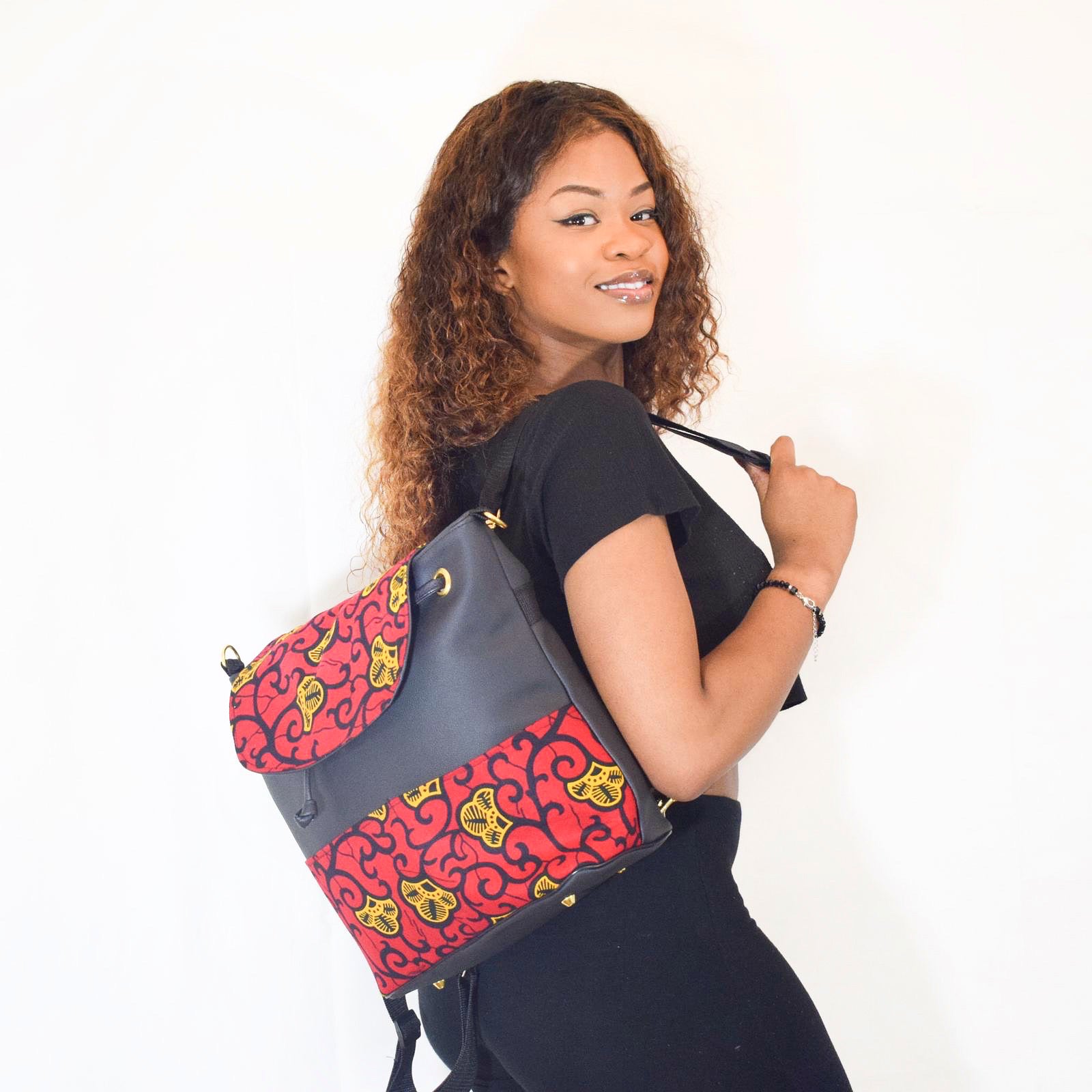 Black multiway backpack with red, yellow and black ankara wax print trim