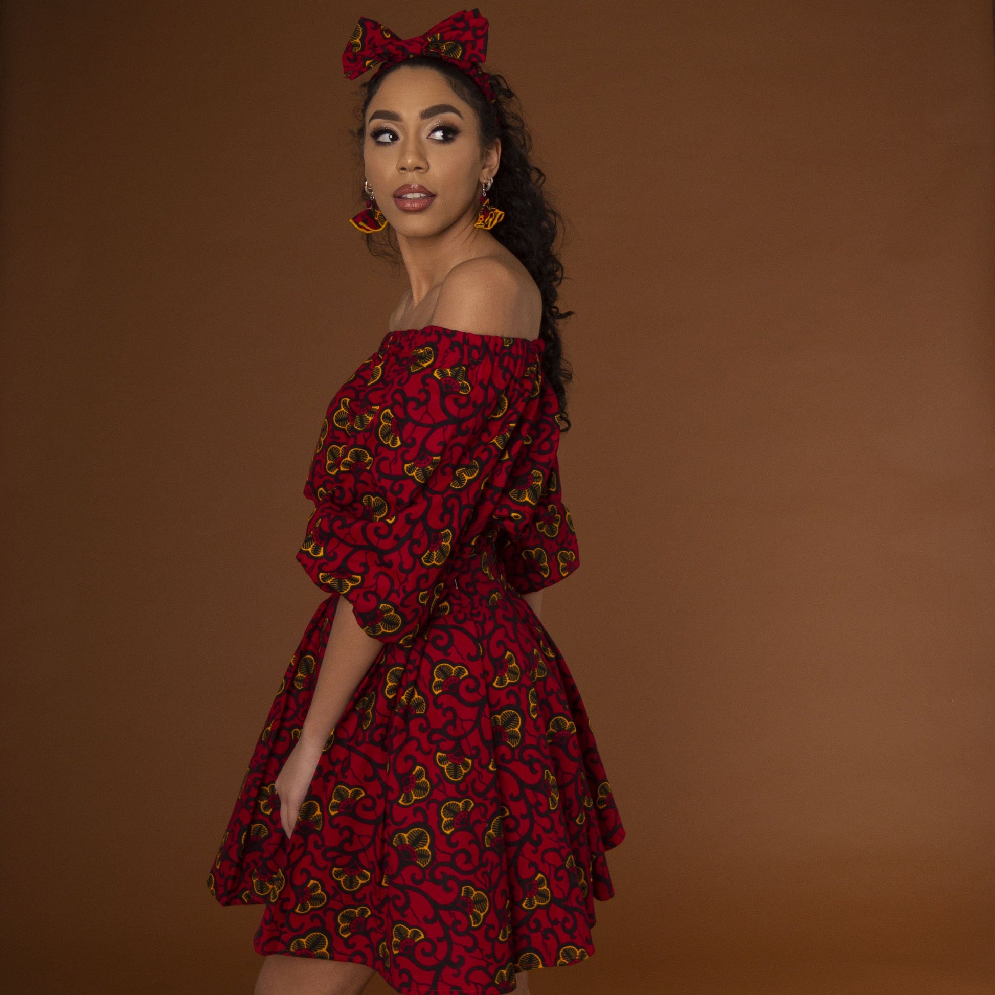 Red, yellow and black African print high waisted pleated skater skirt in a floral pattern, made from sustainably sourced Ankara wax print.