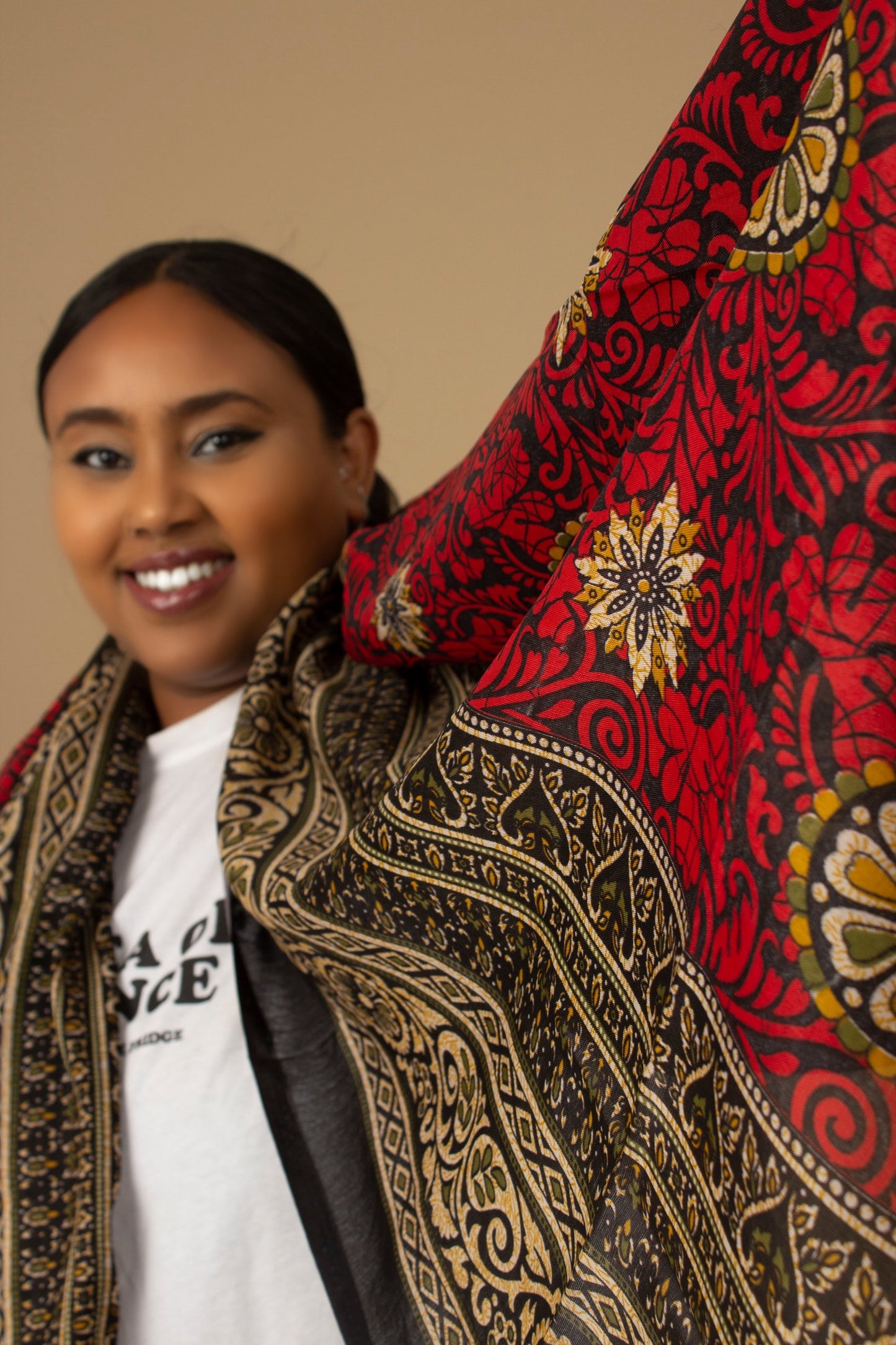 The one-sized Red Dashiki Chiffon Scarf is a vibrant floral African Print in an extremely flattering, red, gold and black African floral dashiki Print pattern. The Red Dashiki Chiffon Scarf is printed on a luxurious Chiffon that is ethically sourced, Designed in England Made in Nigeria. 