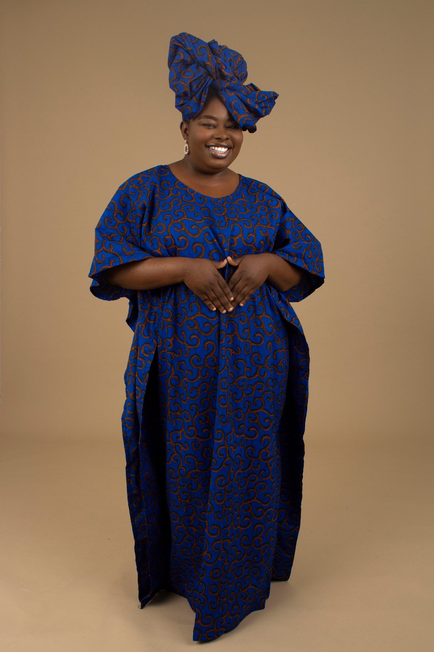 The Ore Floor Length lightweight African Print Kaftan Dress in Ankara wax print in a deep blue and orange swirling African Print pattern is ethically sourced cotton. Designed in England Made in Nigeria. 