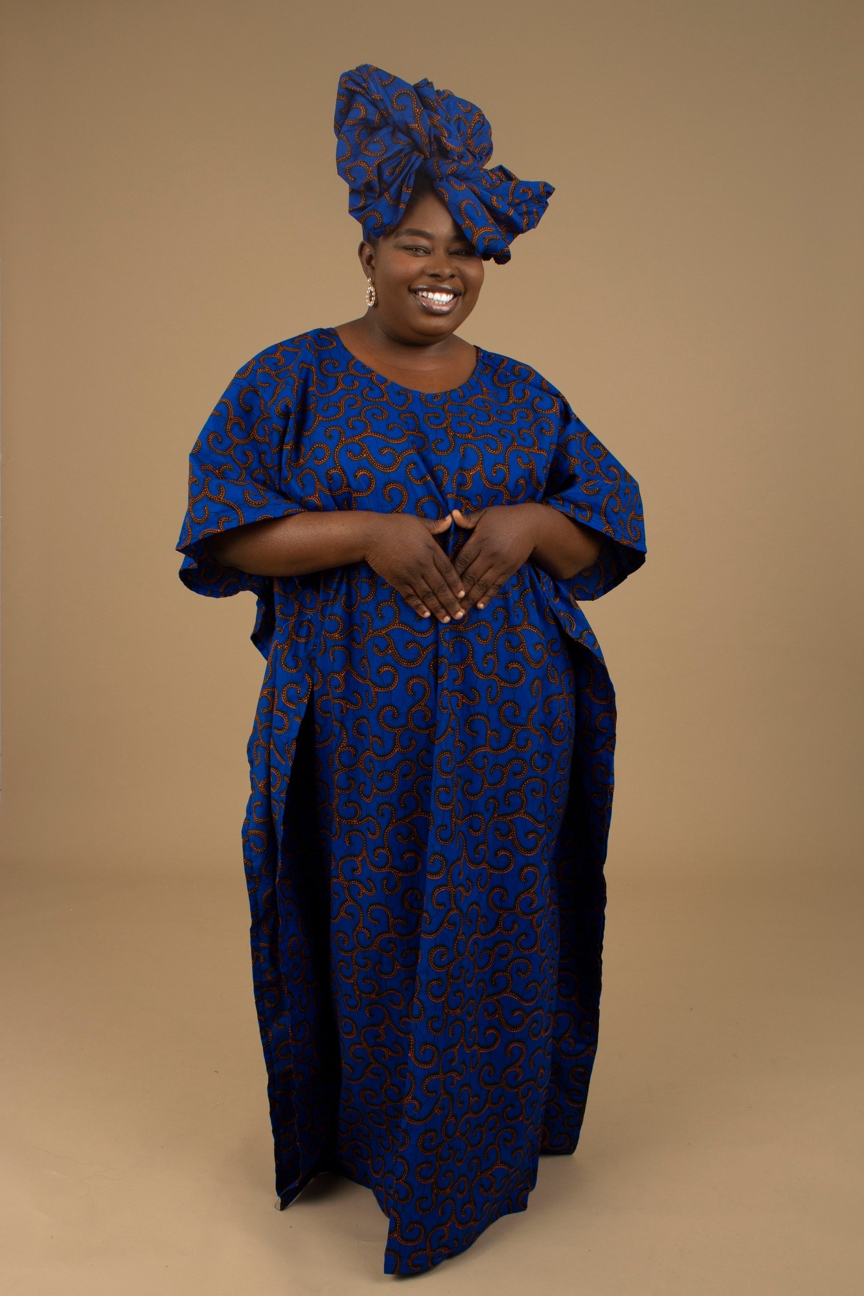 The Ore Floor Length lightweight African Print Kaftan Dress in Ankara wax print in a deep blue and orange swirling African Print pattern is ethically sourced cotton. Designed in England Made in Nigeria. 