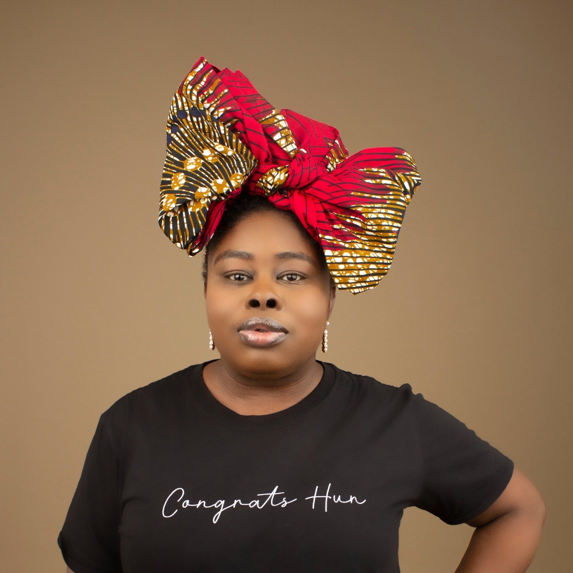 The Ata African Print Head Wrap is a lightweight African Print hair accessory made from ethically produced cotton. The Ankara wax print is a gorgeous red, white and black oversized textured swirl African Print pattern. Designed in England Made in Nigeria.
