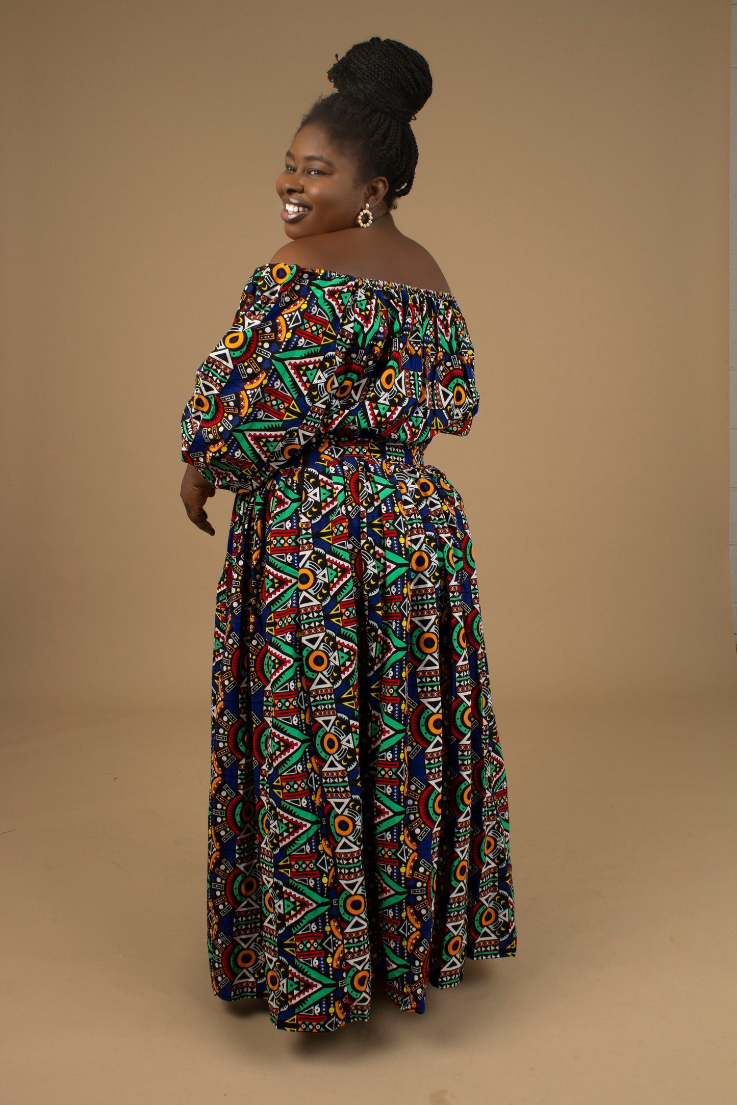 The Ifemi Floor Length African Print High Waisted Maxi Skirt with an enforced waistband and zip in a vibrant Ankara wax, geometric multicolored pattern using sustainable ethically sourced Cotton, designed in England Made in Nigeria.