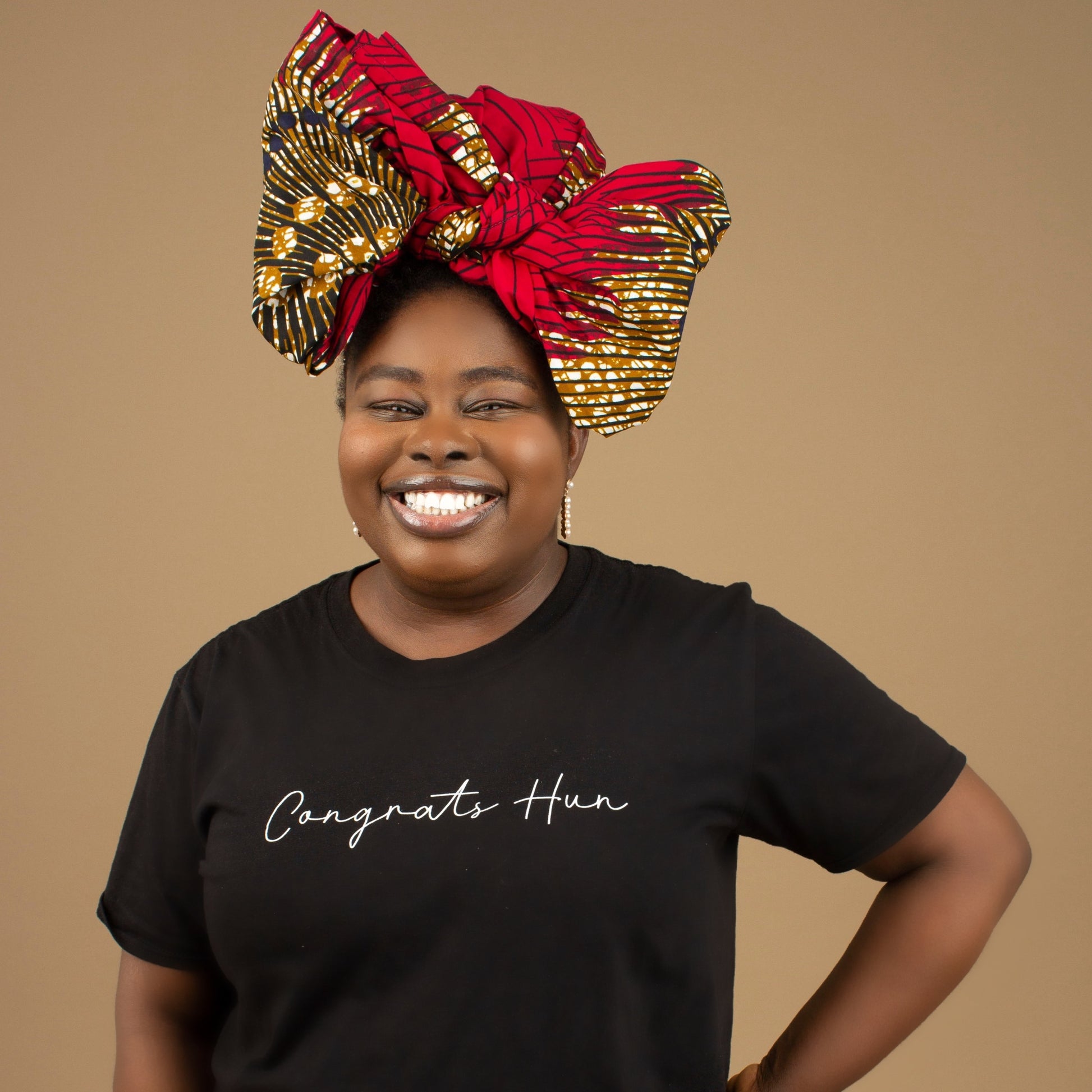 The Ata African Print Head Wrap is a lightweight African Print hair accessory made from ethically produced cotton. The Ankara wax print is a gorgeous red, white and black oversized textured swirl African Print pattern. Designed in England Made in Nigeria.