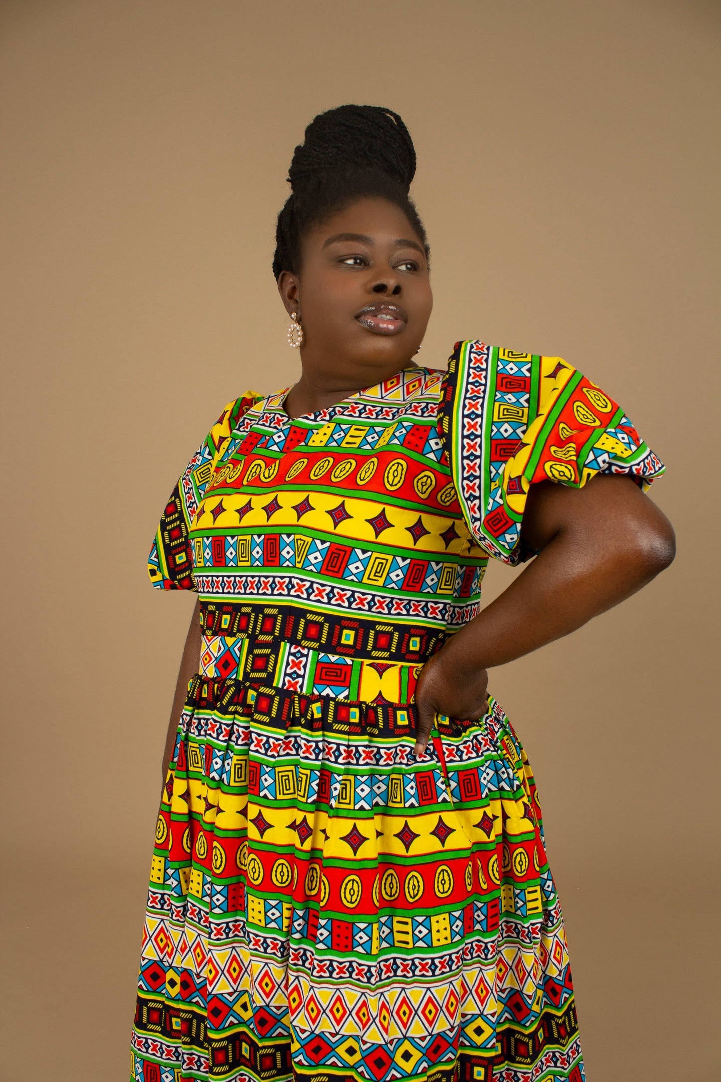 The Akala African Print Skater Dress is crafted from sustainable wax print and features two side pockets in a repeated multi-coloured geometric Kente pattern from cotton. Designed in England Made in Nigeria. Available in standard and plus sizes (UK 8-32).