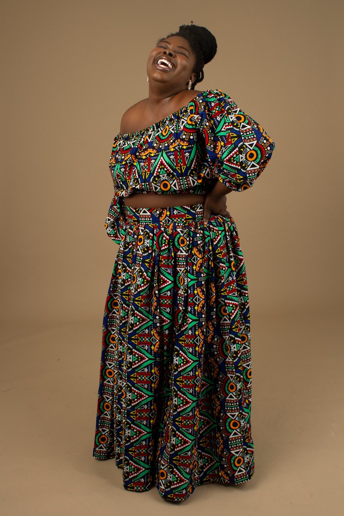 The Ifemi Floor Length African Print High Waisted Maxi Skirt with an enforced waistband and zip in a vibrant Ankara wax, geometric multicolored pattern using sustainable ethically sourced Cotton, designed in England Made in Nigeria.