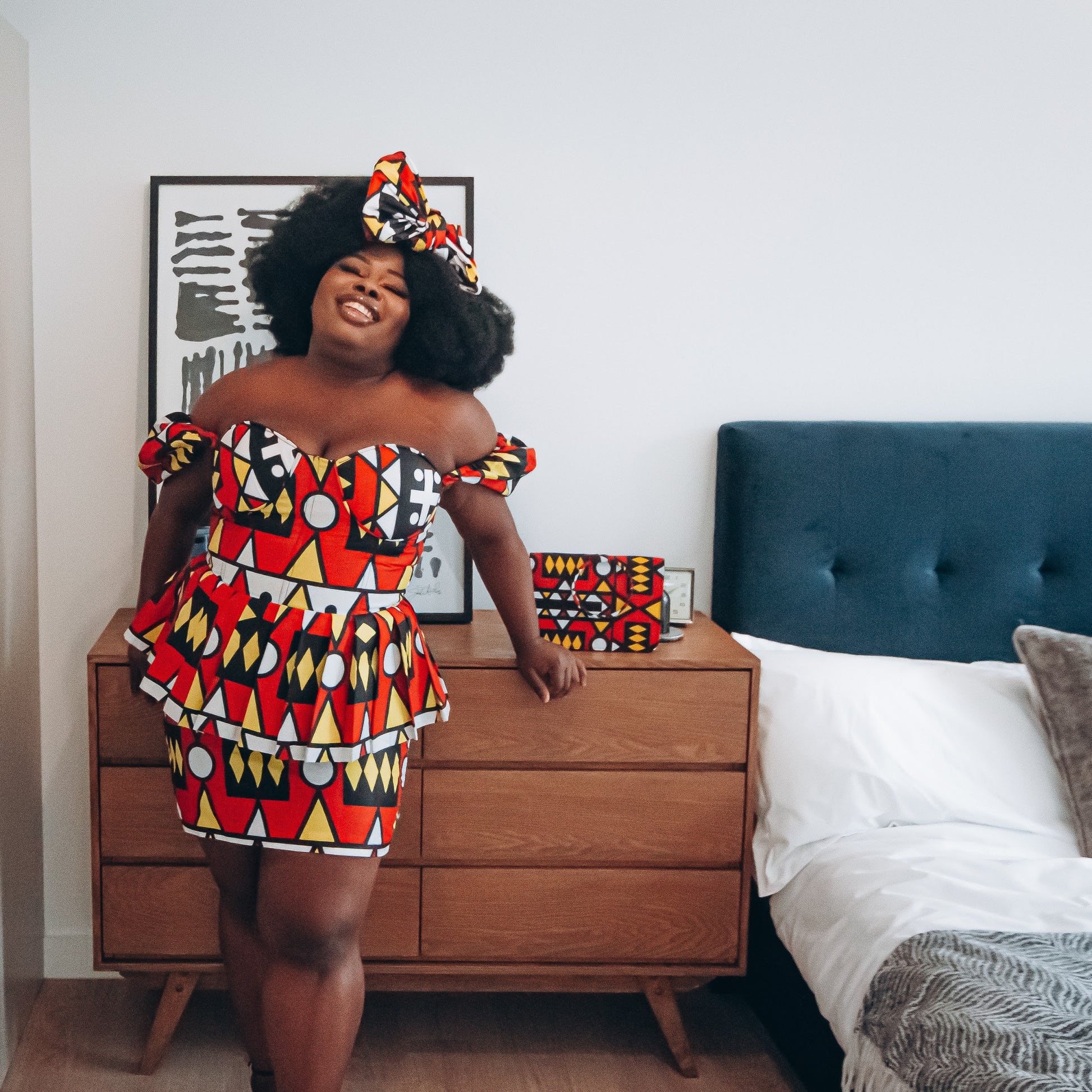 Red, pastel yellow, white and black African printKnee length pencil  skirt, in oversized geo-shaped pattern made from sustainably sourced Ankara wax print
