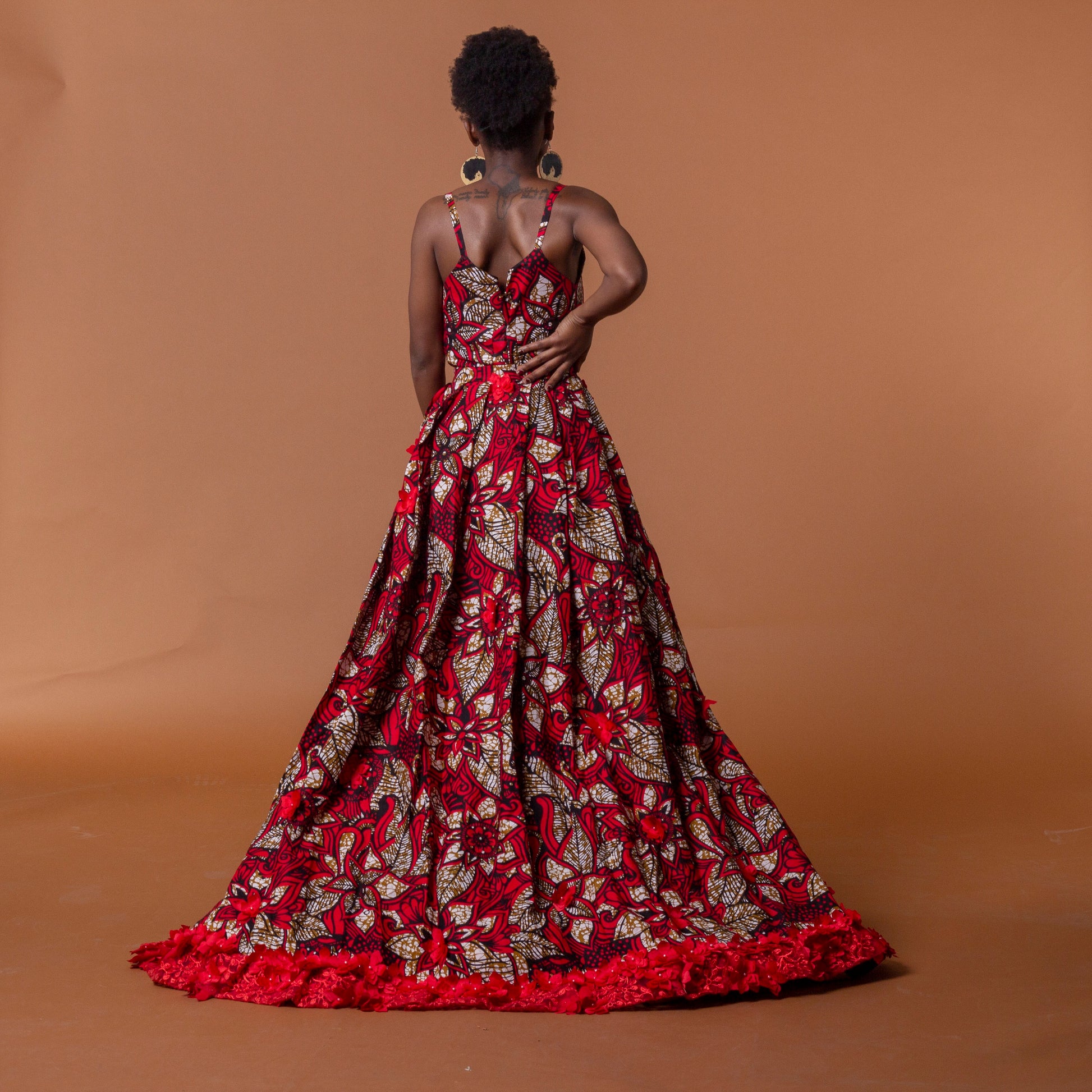 Back view of red african print cape in floral ankara wax print fastened at the waist