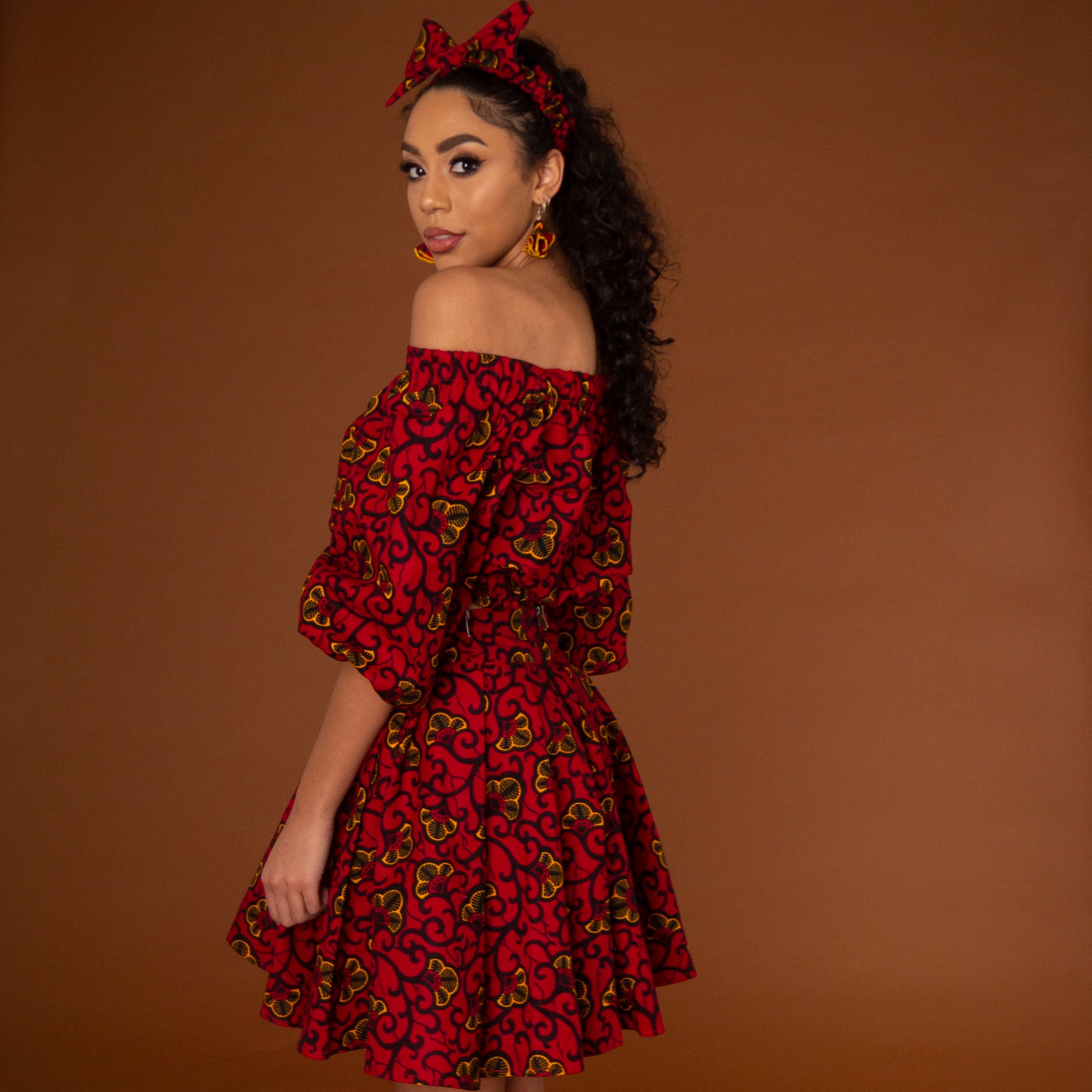 African print balloon sleeve crop top and matching high waisted flare skirt a striking red, yellow and black ankara fabric
